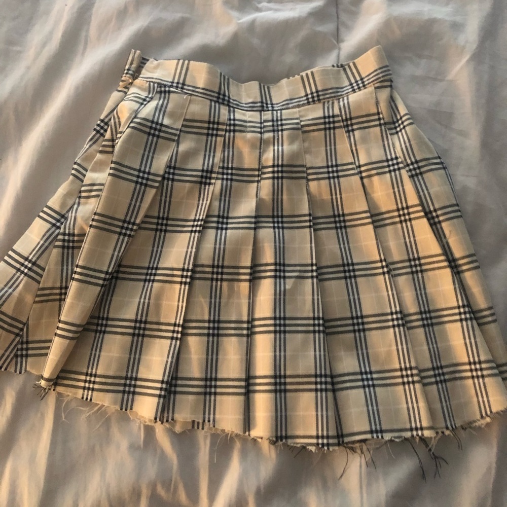 Princess Polly light cream with black and white plaid design mini skirt.